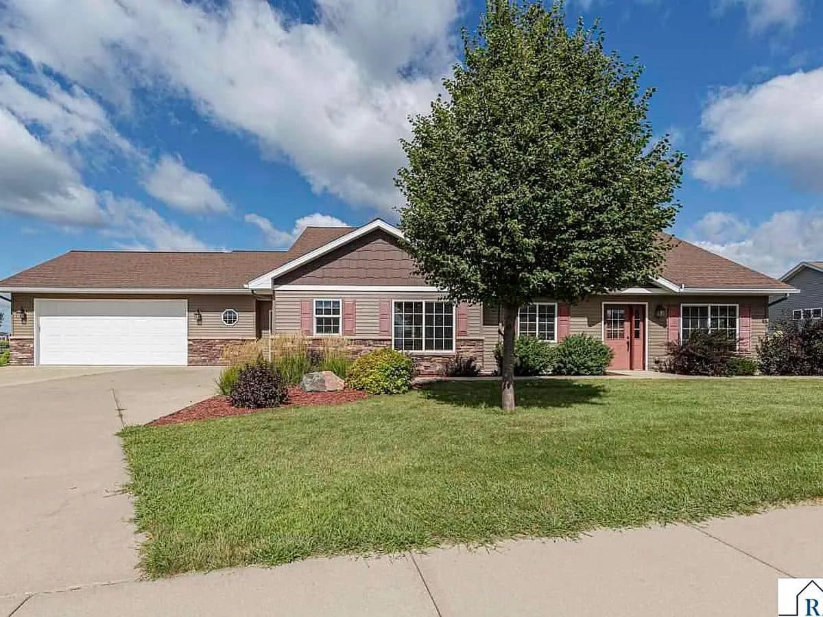Ranch-style patio home with an attached two-car garage and brick-and-siding exterior in North Mankato, MN